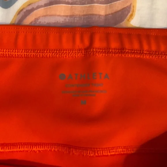 Athleta Orange leggings. Inside pocket for keys or money. Side zipper pockets. - Picture 4 of 5